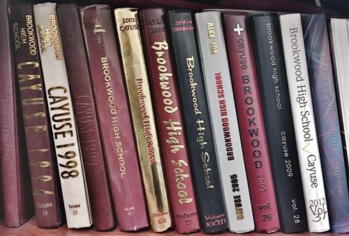 a row of yearbooks on a shelf